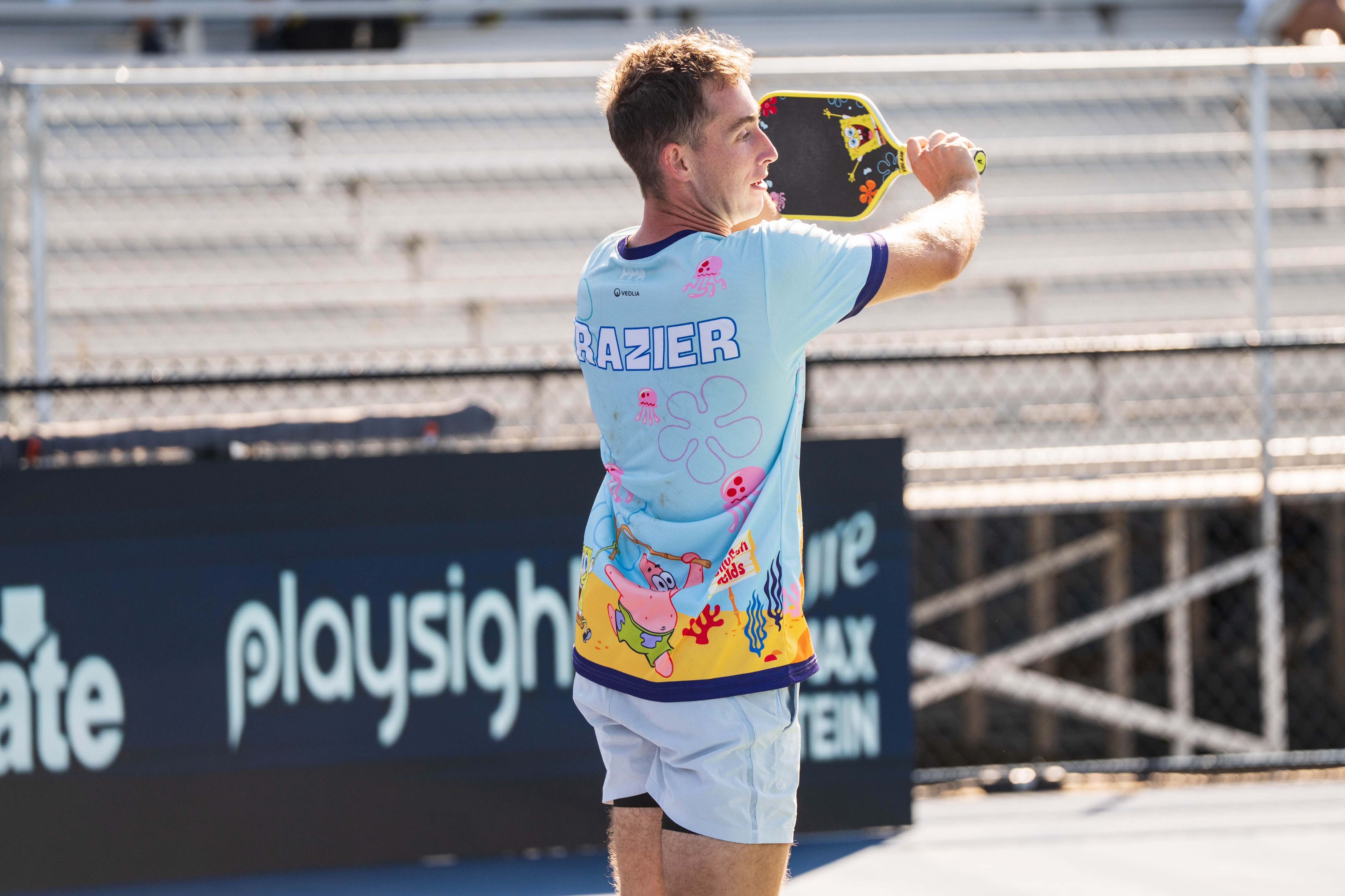 Frazier in a spongebob branded jersey and a spongebob paddle